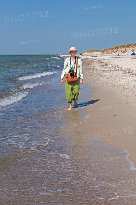 Elderly woman walking barefoot on the beach, Darßer Ort, Born a. Darß, Mecklenburg-Vorpommern, Germany, Europe