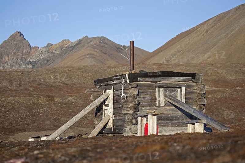 Wooden hunting log cabin tightly shut with logs against raiding polar bears on Svalbard, Spitsbergen, Norway, Europe