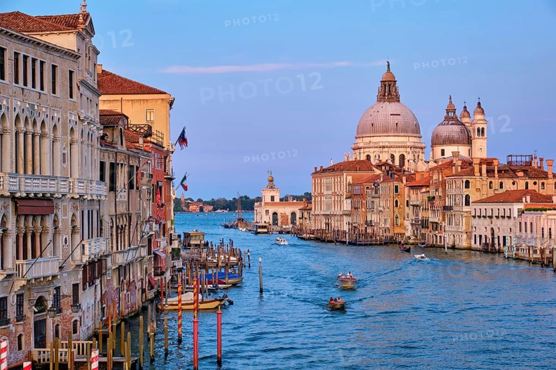Panorama of Venice Grand Canal with boats and Santa Maria della Salute church on sunset from Ponte dell'Accademia bridge. Venice, Italy, Europe
