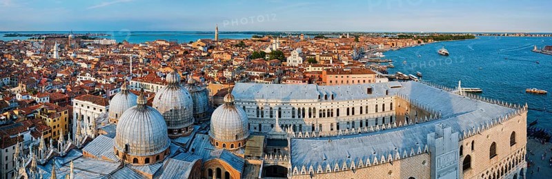 Aerial panorama of Venice with St Mark's Basilica and square and Doge's Palace on sunset from St Mark's Campanile bell tower, Venice, Italy. Camera horizontal pan