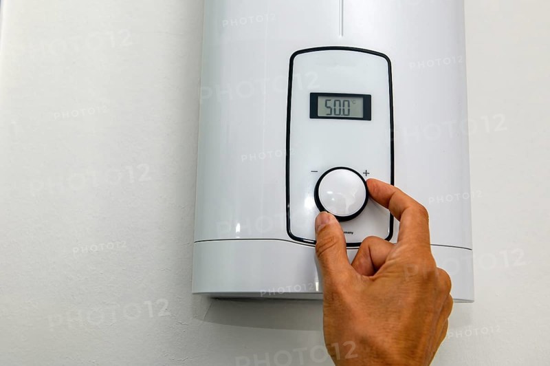Instantaneous water heater for hot water shower washbasin bidet is set at high temperature of 50 degrees Celsius with very high consumption of energy electricity energy consumption electricity consumption, Germany, Europe