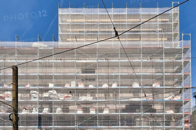 Karlsruhe, Germany, August 2021: Large construction site with scaffolding on multistory building facade during renovation, Europe