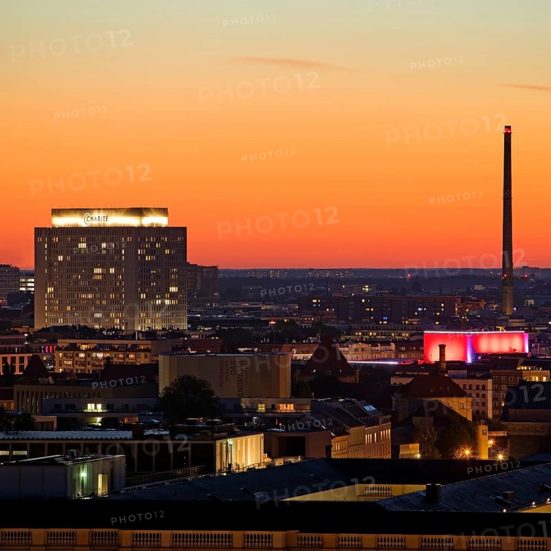 Charité high-rise hospital and the chimney of the Vattenfall combined heat and power plant Scharnhorststraße in the sunset, Berlin, Germany, Europe