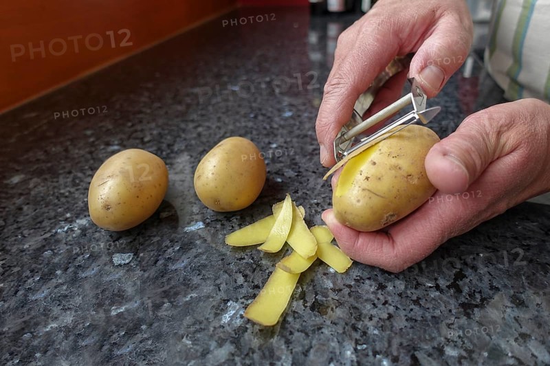 Preparation of cress soup with crisps, peeling potatoes, Swabian cuisine, hearty soup, vegetarian, healthy, salty, typical Swabian cuisine reinterpreted, traditional cuisine, food photography, studio, asparagus peeler, men's hands, worktop, Germany, Europe