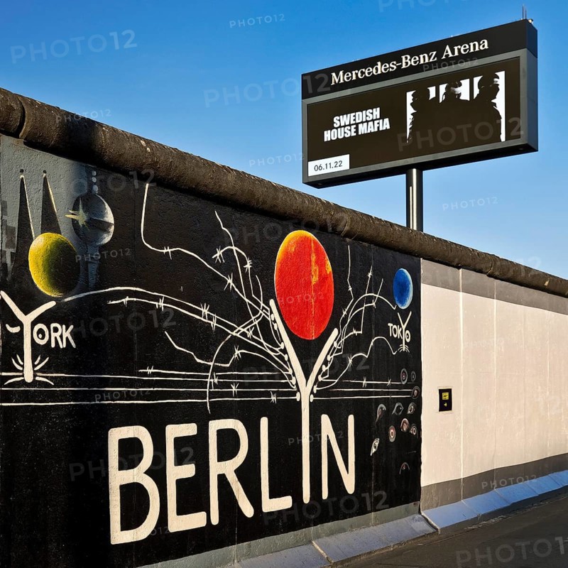 Mural entitled Berlyn on a remnant of the Berlin Wall, artist Gerhard Lahr, with advertising, East Side Gallery, Friedrichshain, Berlin, Germany, Europe