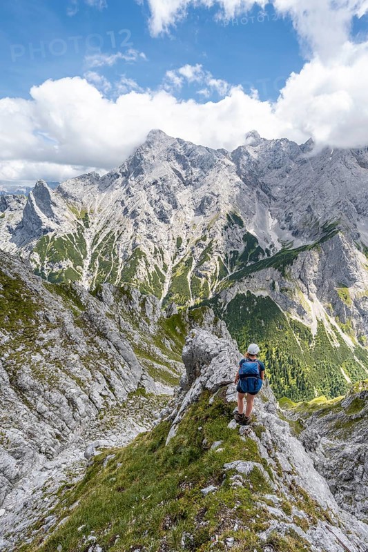 Mountaineer climbing Waxenstein, Alpspitze Wetterstein range in the background, Garmisch-Patenkirchen, Bavaria, Germany, Europe