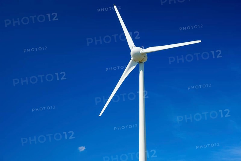 Green renewable alternative energy concept, wind generator turbines generating electricity in blue sky