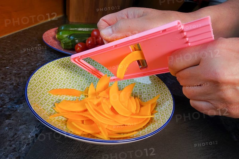 Swabian cuisine, preparing pumpkin for mini dinettes, slicing vegetables, vegetable slicer, healthy, vegetarian, typical Swabian reinterpreted, man's hand, plate, traditional cuisine, food photography, studio, Germany, Europe