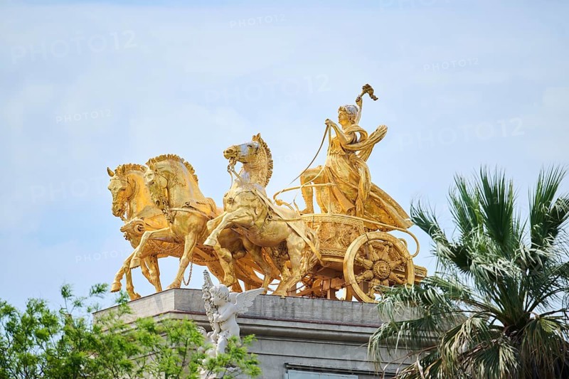 Golden sculpture of a chariot driver with three horses pulling the chariot, Barcelona, Spain, Europe