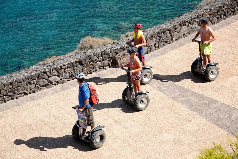 Tourists taking a ride with Segway Personal Transporters along the sea, Lanzarote, Canary Islands, Spain, Europe