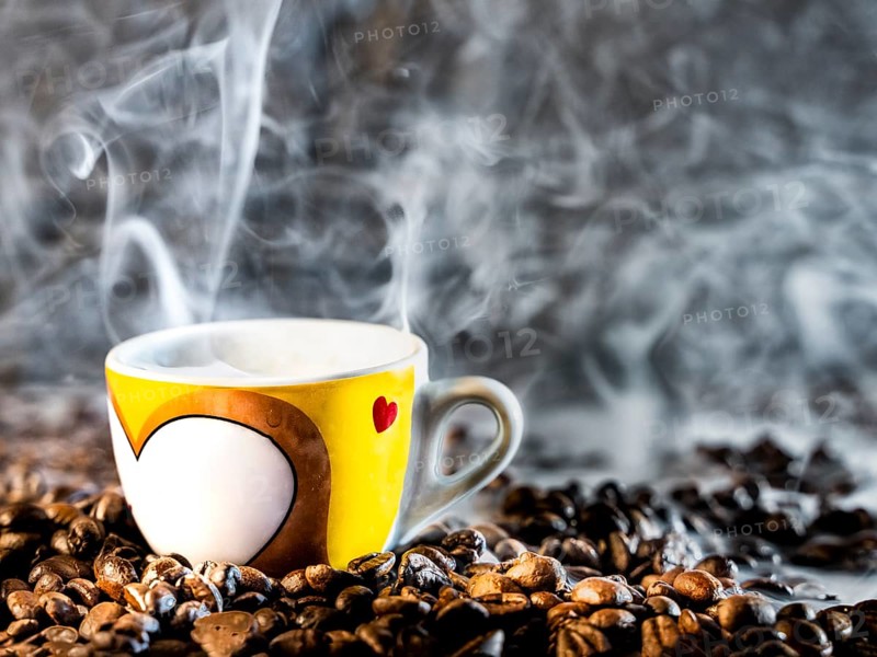Espresso cup and rosted Coffee beans with some mist around