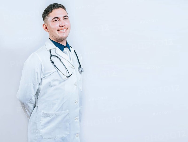 Portrait of smiling young doctor isolated. Portrait of latin doctor isolated with copy space