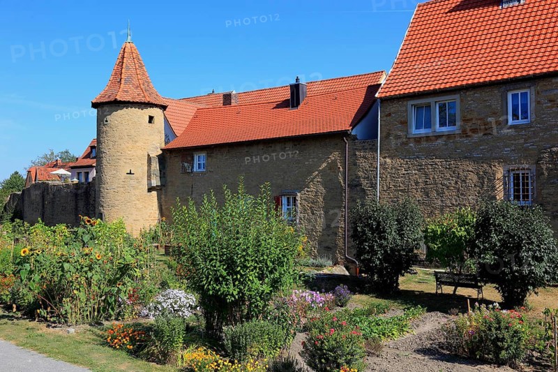 Part of the old town wall and in front of it the moat gardens, Mainbernheim, Lower Franconia, Germany, Europe