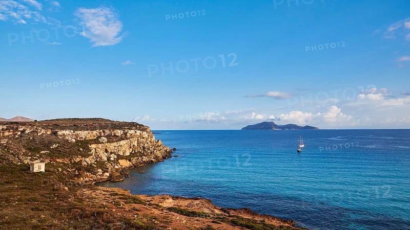 Rocky coast, sailing boats, Levanzo Island, Scogliera di Cala Rossa, Cala Rossa, Favignana, Egadi Islands, Sicily, Italy, Europe