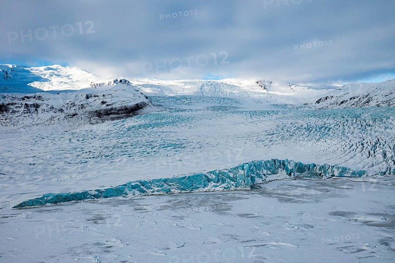 Snow-covered icebergs in the Fjallsarlon glacier lagoon, with the Öraefajökull glacier behind, drone shot, Sudurland, Iceland, Europe