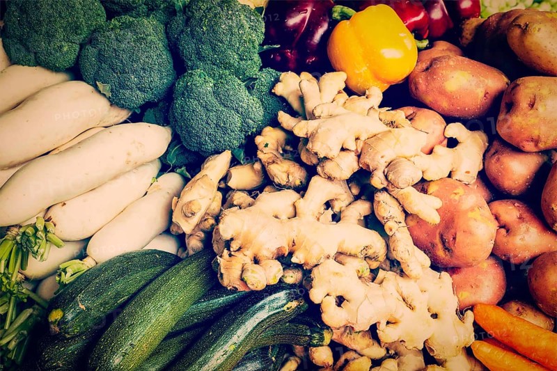 Vintage retro effect filtered hipster style image of Vegetables in Asian market close up, zucchini bell peppers (Capsicum), potatoes, ginger, broccoli cabbage, daikon white radish