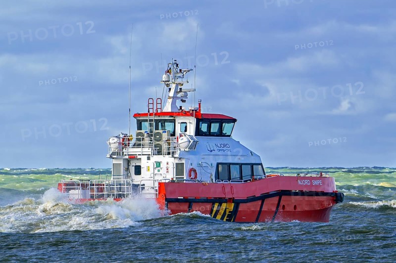 Njord Snipe, catamaran operated by Njord Offshore Ltd, crew transfer vessel for offshore windfarm sector sailing on the North Sea in stormy weather