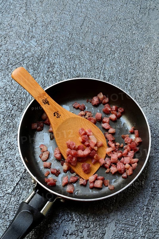 Fried bacon cubes in pan, bacon