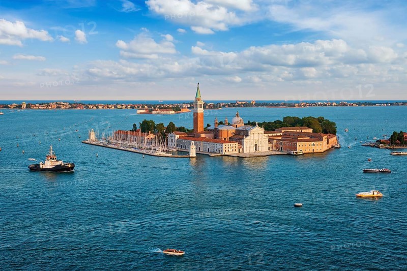Famous Italy tourist destination, aerial view of Venice lagoon, San Giorgio di Maggiore church San Marco square with boats and vaporetto on sunset from St Mark's Campanile bell tower, Venice, Italy, Europe
