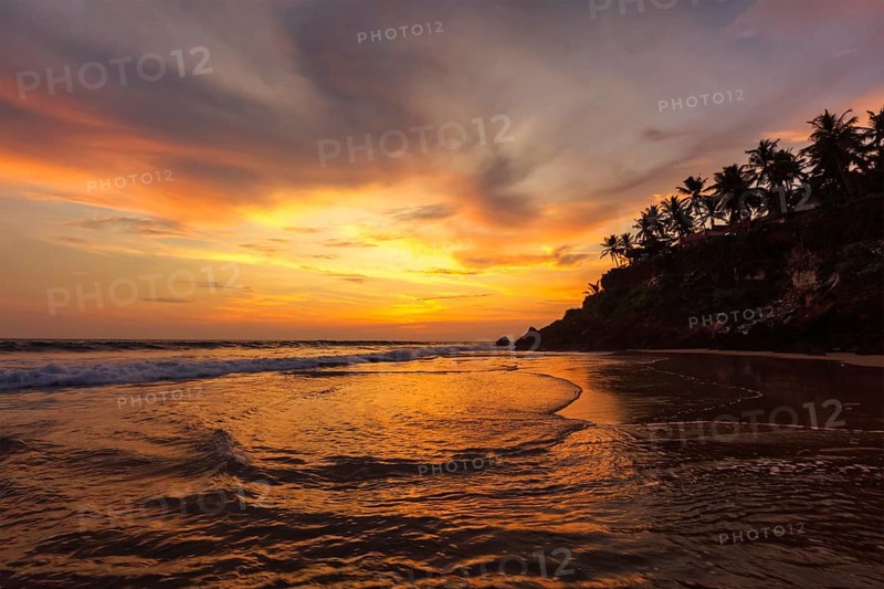 Sunset on Varkala beach popular tourist destination in Kerala state, South India