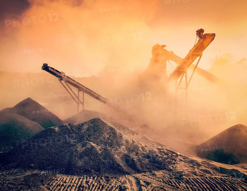 Vintage retro effect filtered hipster style image of Industrial hell pollution concept, crusher rock stone crushing machine at open pit mining and processing plant for crushed stone sand and gravel