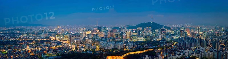 Panorama of Seoul downtown cityscape illuminated with lights and Namsan Seoul Tower in the evening view from Inwang mountain. Seoul, South Korea, Asia