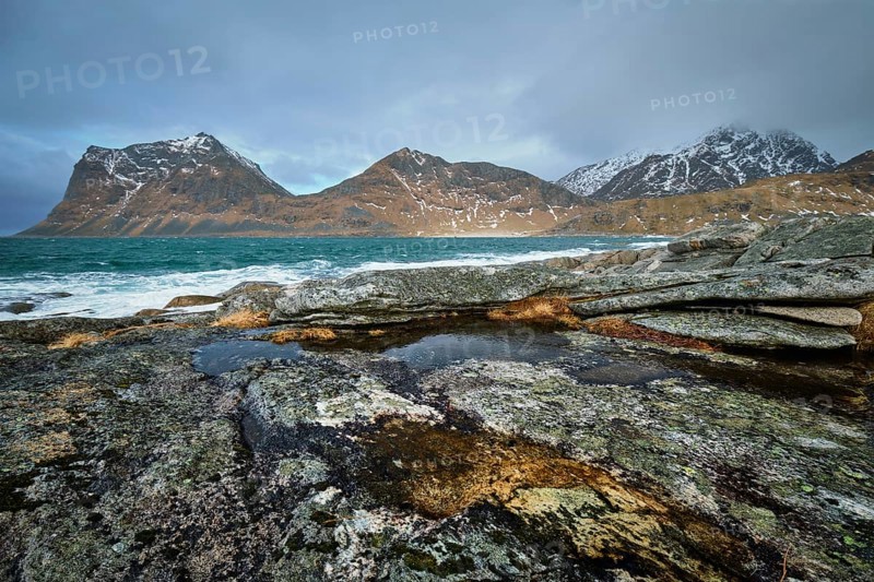 Rocky coast of fjord of Norwegian sea in winter. Lofoten islands, Norway, Europe