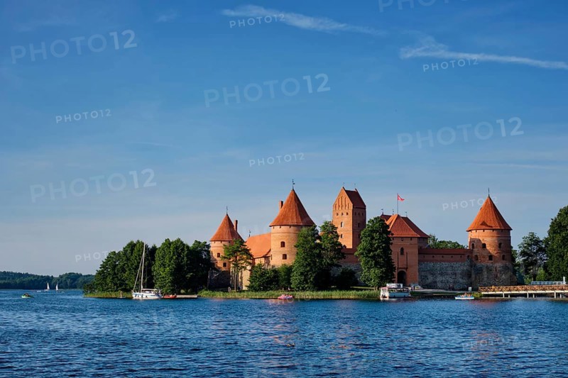 Trakai Island Castle in lake Galve with boats and yachts in summer day with beautiful sky, Lithuania. Trakai Castle is one of major tourist attractions of Lituania