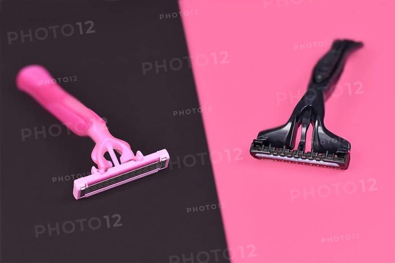 Gender stereotypes concept showing pink and black razor aimed at specific genders
