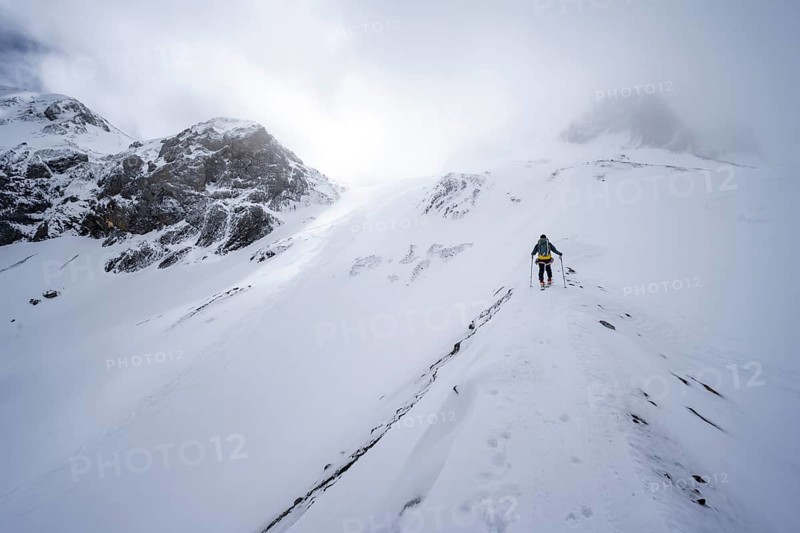 Ski tourers in a snowy mountain landscape, ascent to the Wildhorn, cloudy mood, high tour, Bernese Alps, Bernese Oberland, Switzerland, Europe