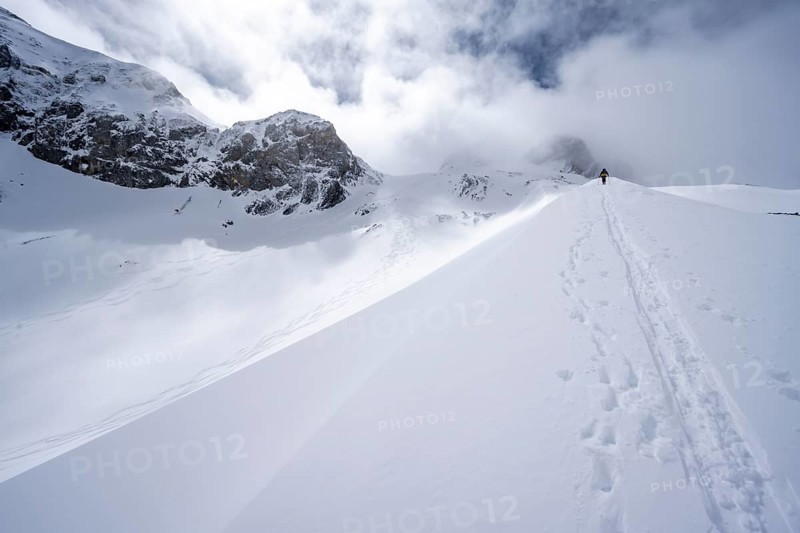 Ski tourers in a snowy mountain landscape, ascent to the Wildhorn, cloudy mood, high tour, Bernese Alps, Bernese Oberland, Switzerland, Europe