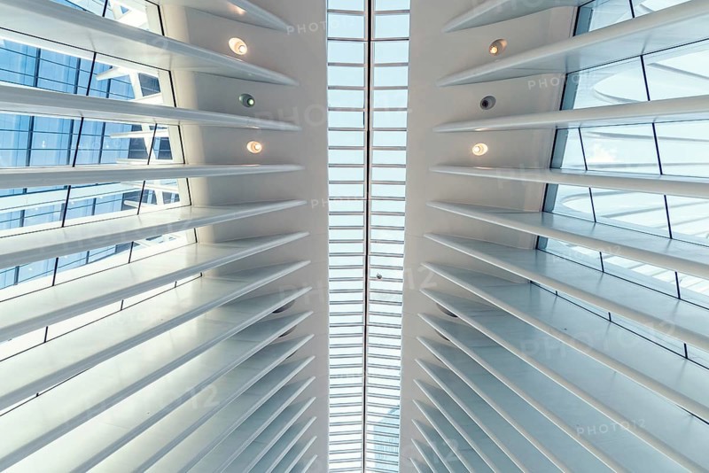 New York City, USA, June 24, 2018: Interior view of World Trade Center Transportation Hub or Oculus designed by Santiago Calatrava architect. Low angle view of white ceiling with abstract geometry of futuristic architecture building, North America