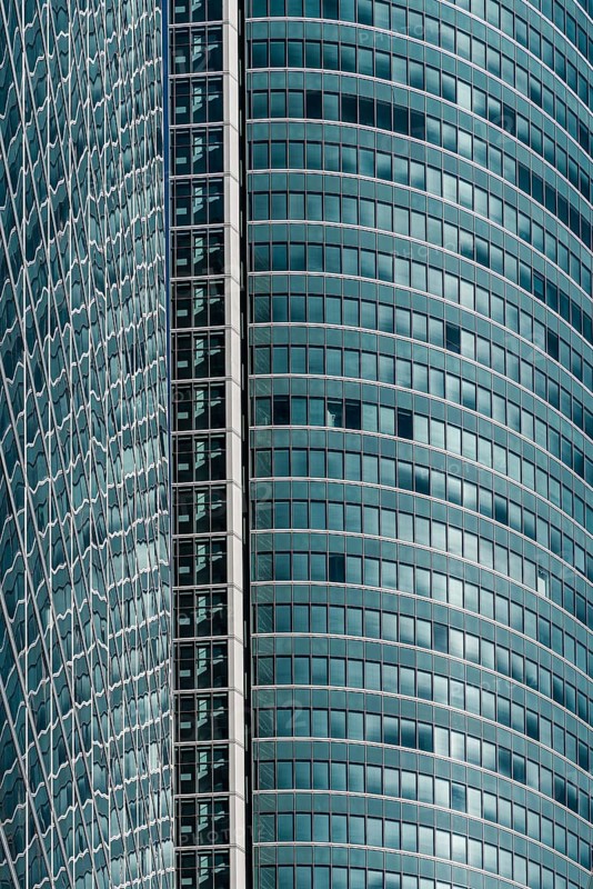 Madrid, Spain, February 7, 2021: Full frame of glass facade of skyscraper in Cuatro Torres financial district. Business and finance concept, Europe
