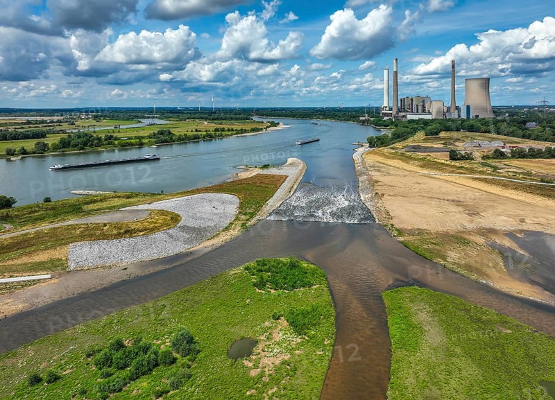 Dinslaken, Voerde, North Rhine-Westphalia, Germany, Renaturalisation of the Emscher. New Emscher estuary into the Rhine. The decommissioned STEAG coal-fired power station in Voerde in the background. The mouth of the Emscher into the Rhine was moved from Dinslaken to Voerde, just under 500 metres to the north. Fish can now swim barrier-free up the new Emscher from the Rhine through a newly created floodplain area. Following the construction of a parallel sewer, the Emscher has been completely free of sewage since January 2022. The river was previously an open, above-ground combined sewer with rainwater and wastewater, Europe