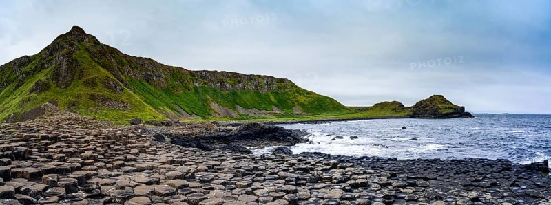 A panorama landscape view of the many volcanic basalt columns of the Giant's Causeway in Northern Ireland