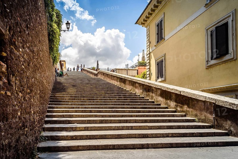 Rome, Italy, August 18, 2016: Lateral staircase to Piazza della Trinita dei Monti with artist painting a sunny summer day. It is a main square in the historical centre of Rome, Europe