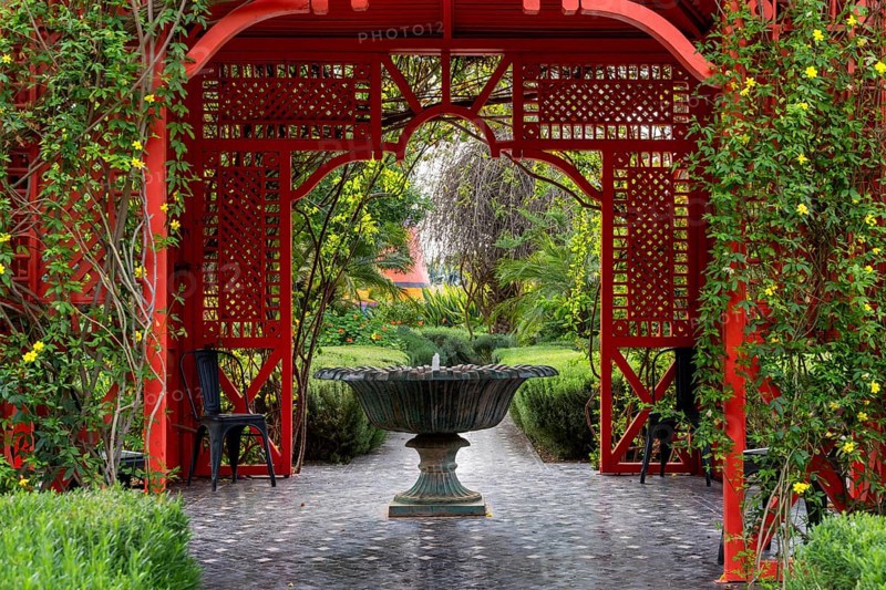 Marrakesh, Morocco, 24 March, 2024: fountain and red gazebo in the heart of the Anima Garden in Marrakesh, Africa
