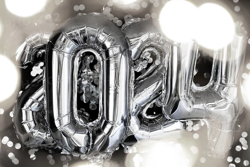 Holiday bokeh garland Happy new year 2024 metallic balloons with confetti on dark black background. Greeting card silver foil balloons numbers Christmas holiday concept. Celebration party congratulation decoration