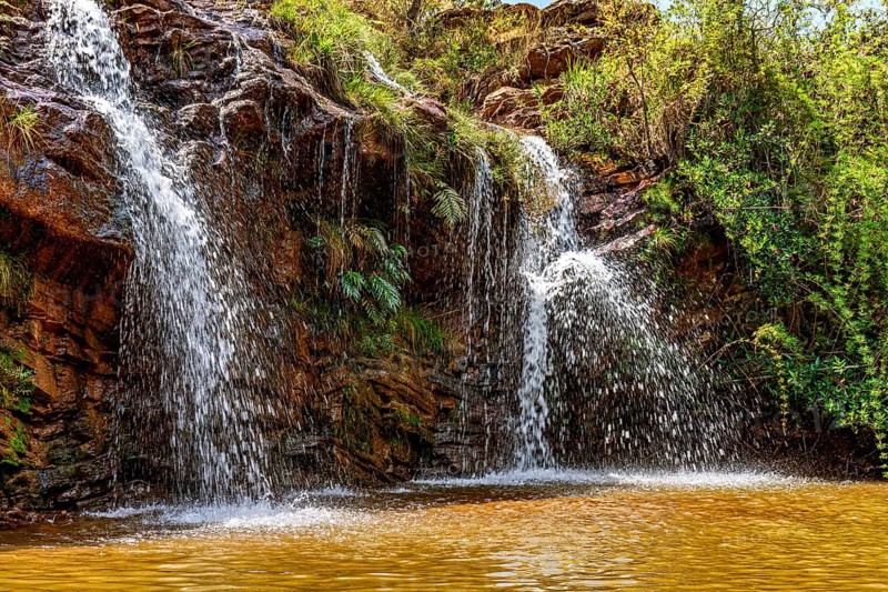 Waterfall among the rocks and vegetation in the Muaimii environmental reserve in the state of Minas Gerais