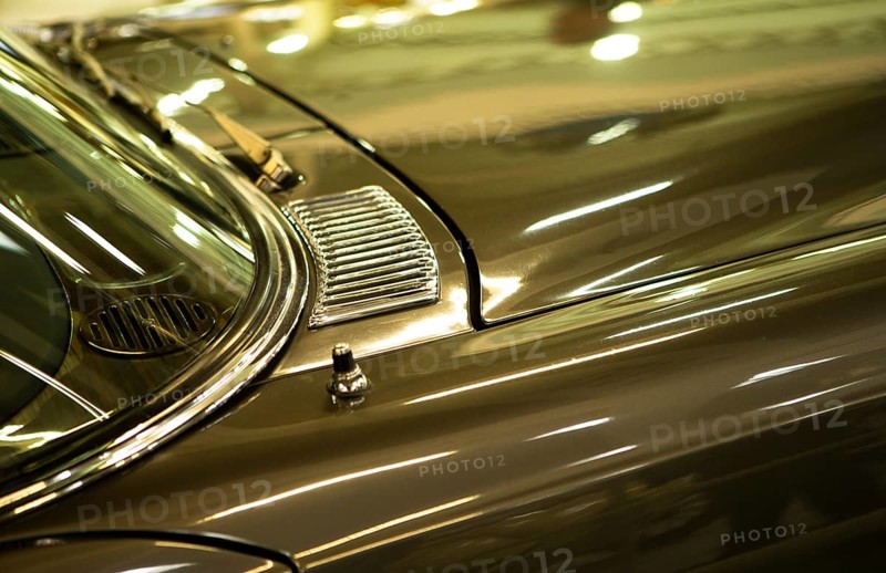 The photo shows a detailed view of a gleaming classic car