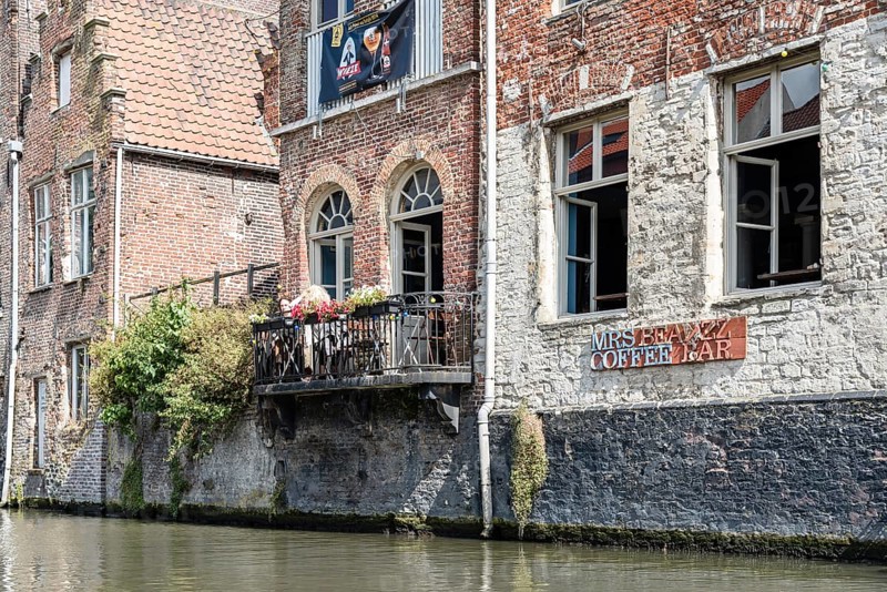 Ghent, Belgium, July 31, 2016: People sitting on a restaurant terrace in Embankment Graslei in the historic center of Ghent with picturesque old buildings, Europe