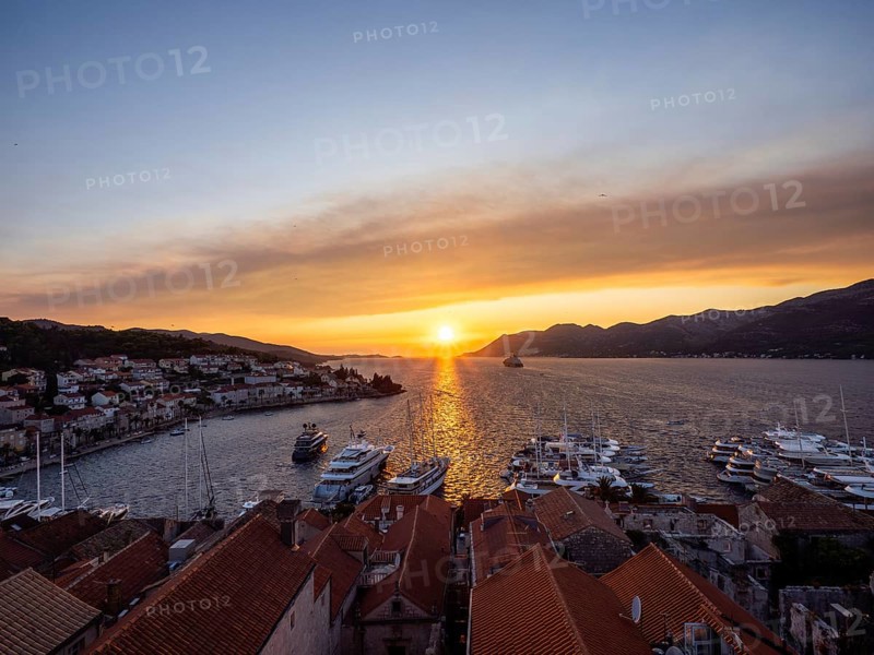 Evening atmosphere at sunset by the sea, view from the bell tower, ships in Korcula harbour, Korcula island, Dalmatia, Croatia, Europe