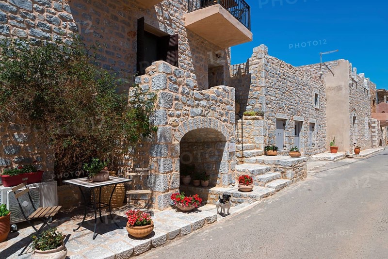 Charming stone alley with flowers in a sunny village, Geromilenas, Mani, Laconia, Peloponnese, Greece, Europe