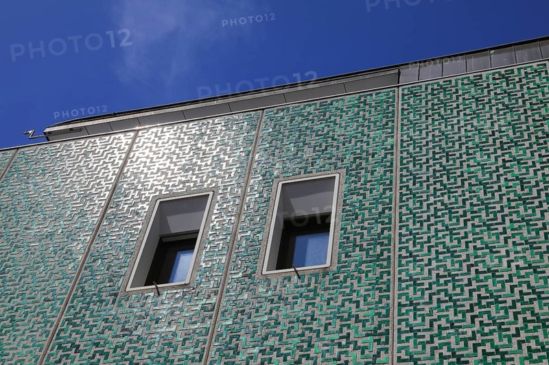 Head office of Sparkasse Fürstenfeldbruck, Upper Bavaria, Bavaria, Germany, Modern green façade of a building with structured patterns and two windows against a blue sky, Europe