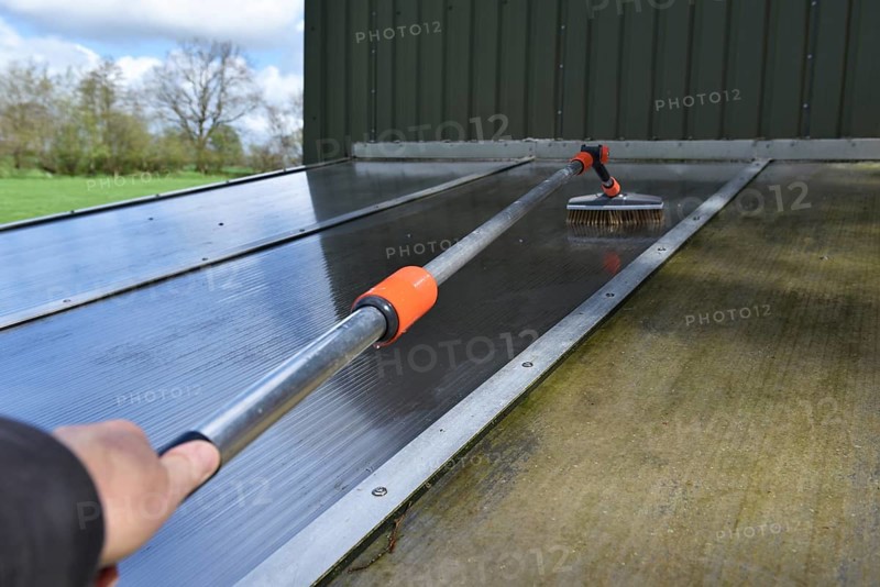 Clean patio roof with telescopic pole and brush