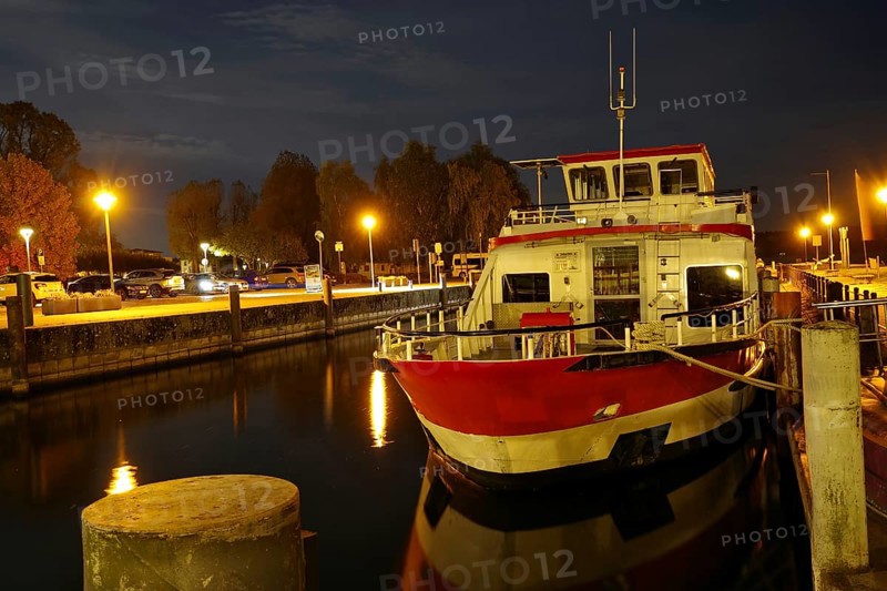 Illuminated excursion boat in the harbour at night, reflected in the calm water, Waren, Müritz, Müritz National Park, Mecklenburg-Vorpommern, Germany, Europe