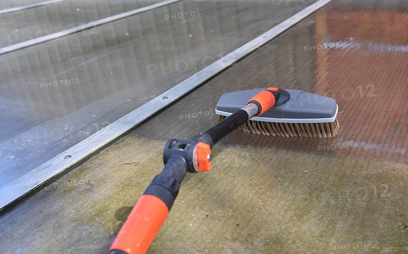 Clean patio roof with telescopic pole and brush