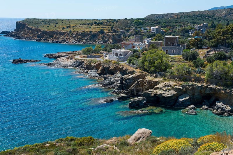 Coastal landscape with rocky shores, clear blue water and picturesque houses under a clear sky, Kyparissos, Mani, Laconia, Laconia, Peloponnese, Greece, Europe