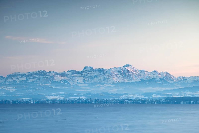 Snow-covered mountains in the Alpstein with Säntis in the background of a lake at dusk with wintry flair, harbour, Immenstaad, Lake Constance, Baden-Württemberg, Germany, Europe