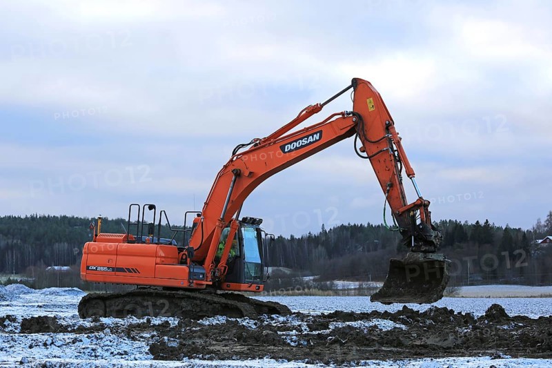 SALO, FINLAND, NOVEMBER 27, 2016: Doosan DX255LC Medium Crawler Excavator at work in the road construction project on a cloudy day of winter in Salo